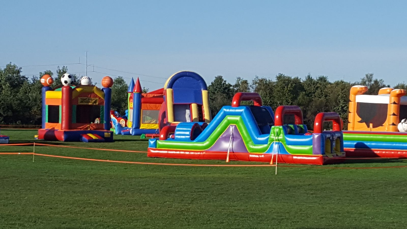 31' Wacky 7-Element Obstacle Course with other Bounce House Rentals at church event.